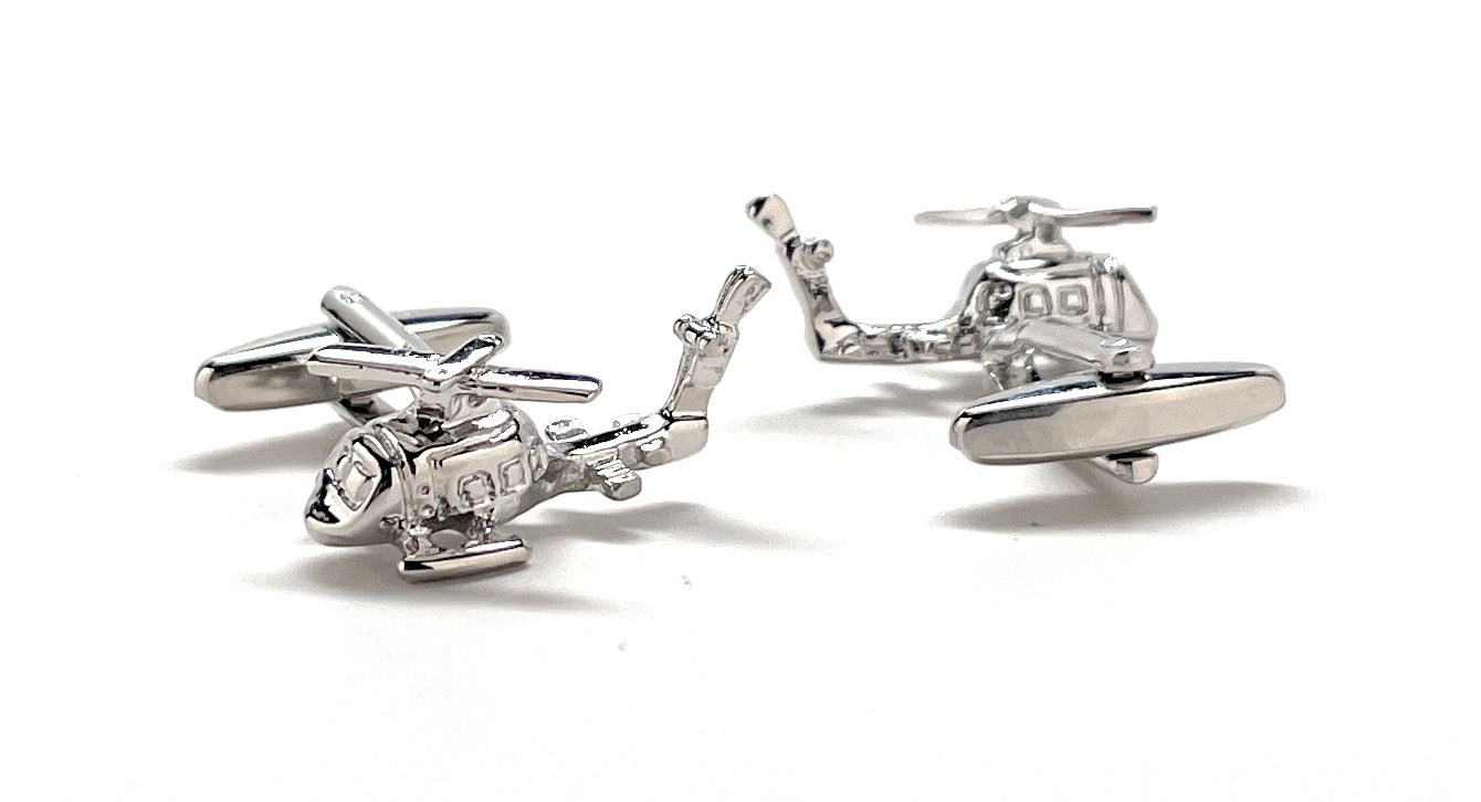 Helicopter-shaped cufflinks on a white background