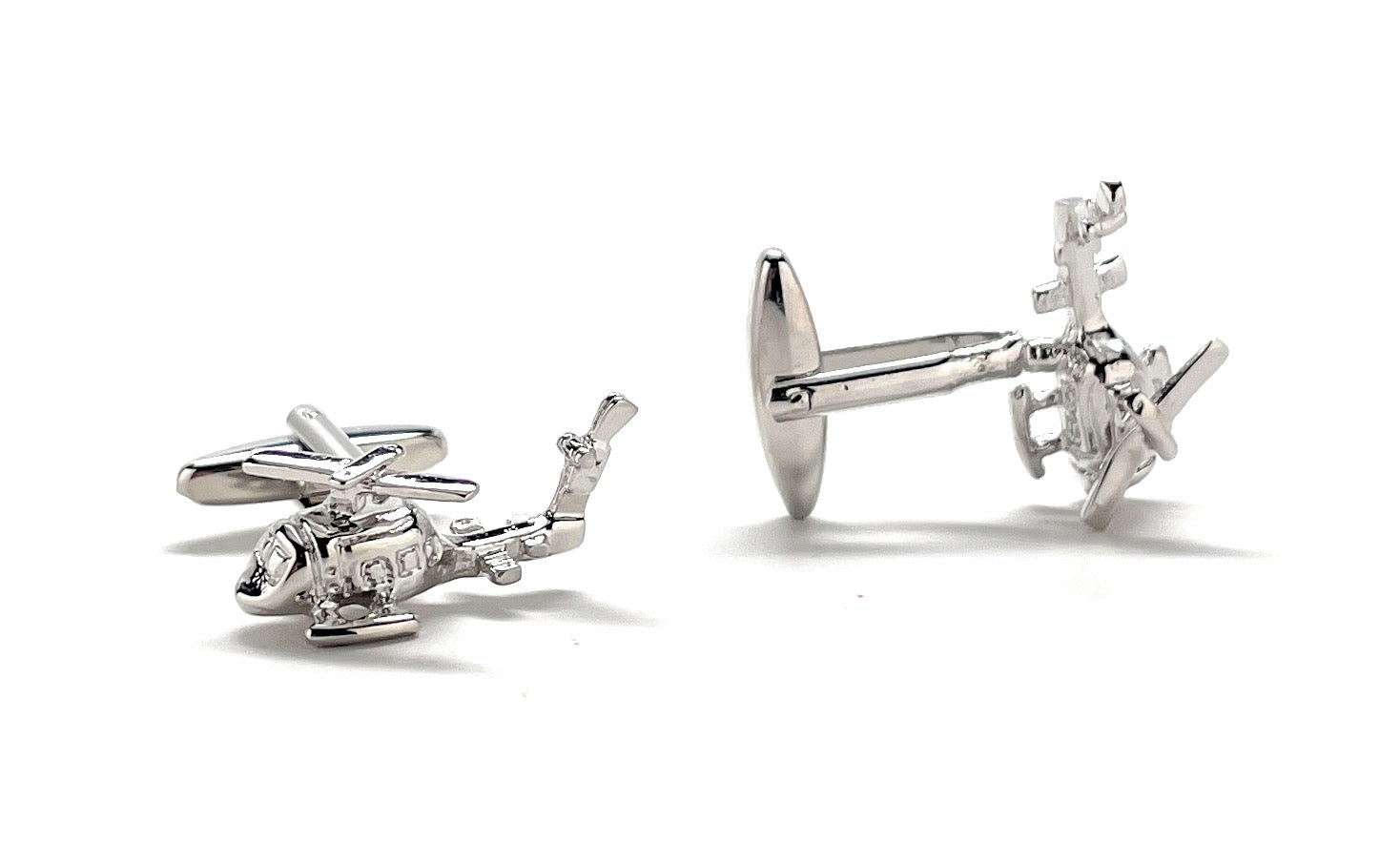 Silver helicopter cufflinks on a white background
