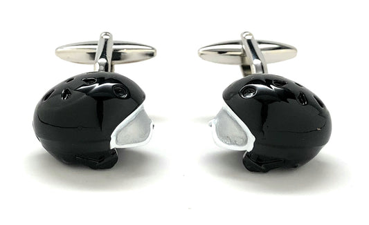 Black and silver penguin-shaped cufflinks on a white background