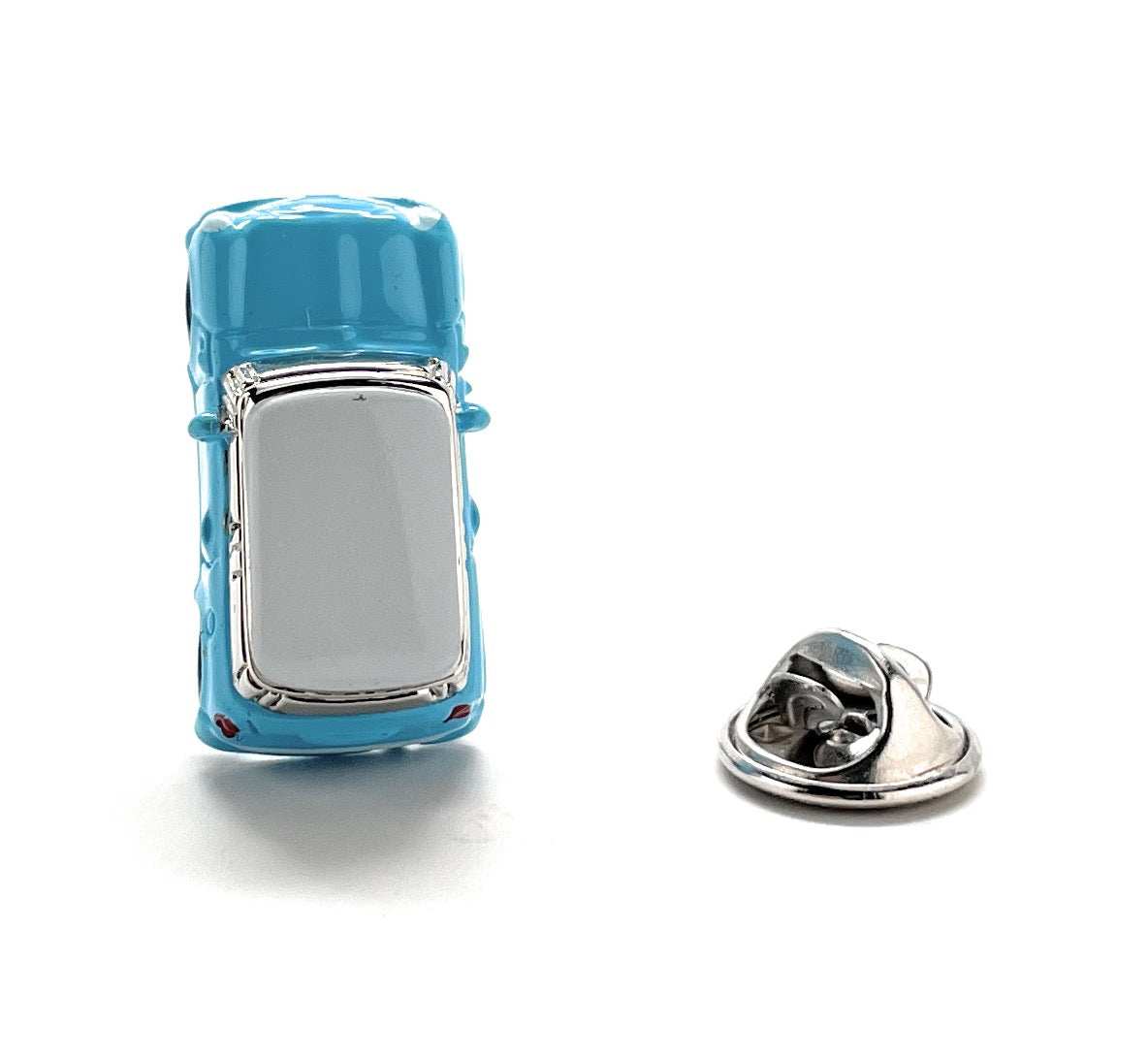 Blue car-shaped pin with a silver clasp on a white background