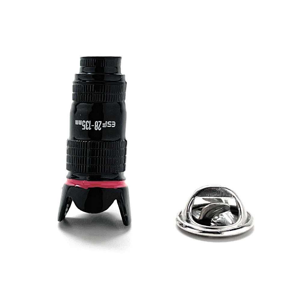 Black monocular with red accents and a metal ring on a white background