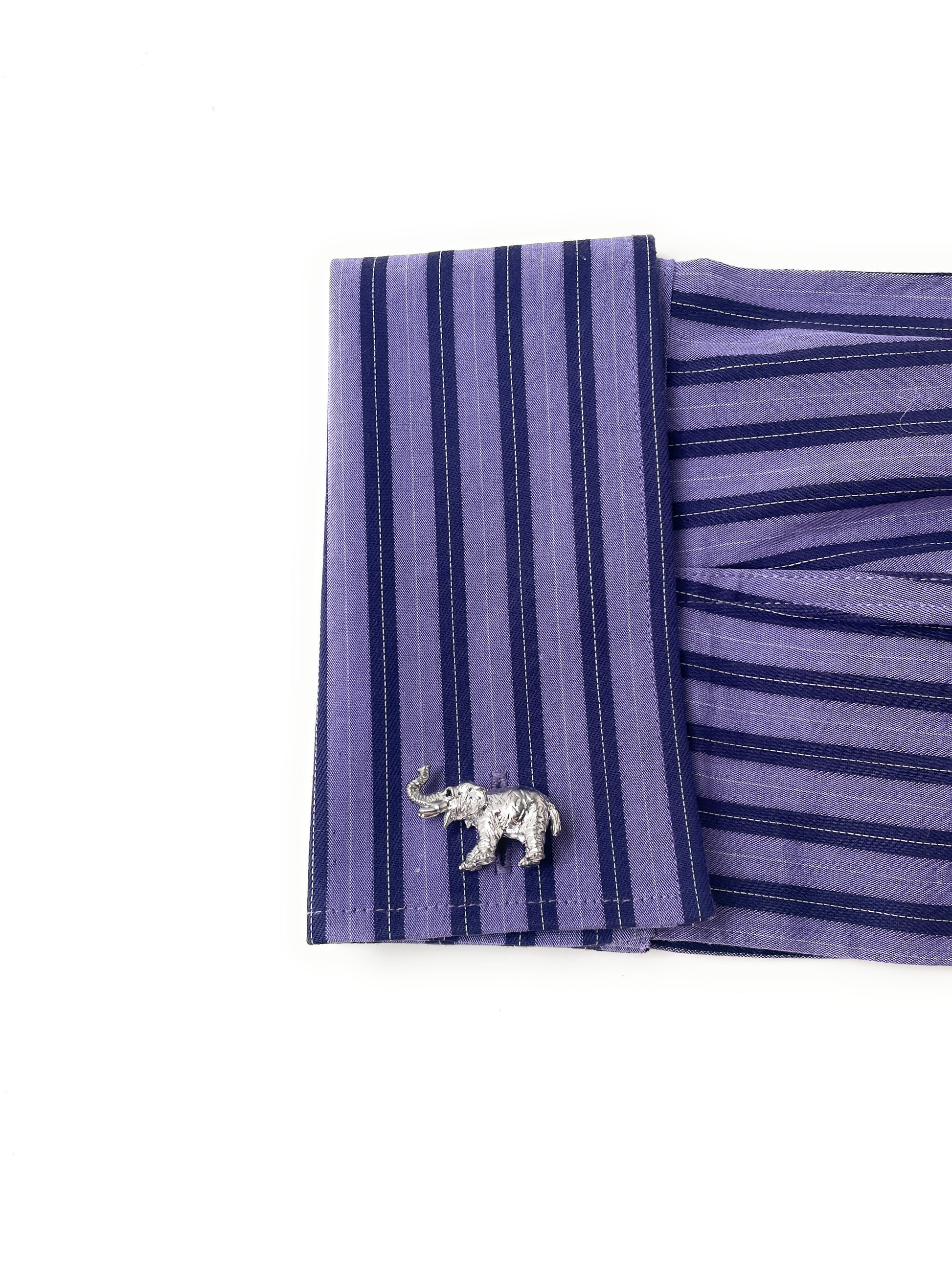 Purple striped shirt with a silver elephant pin on a white background