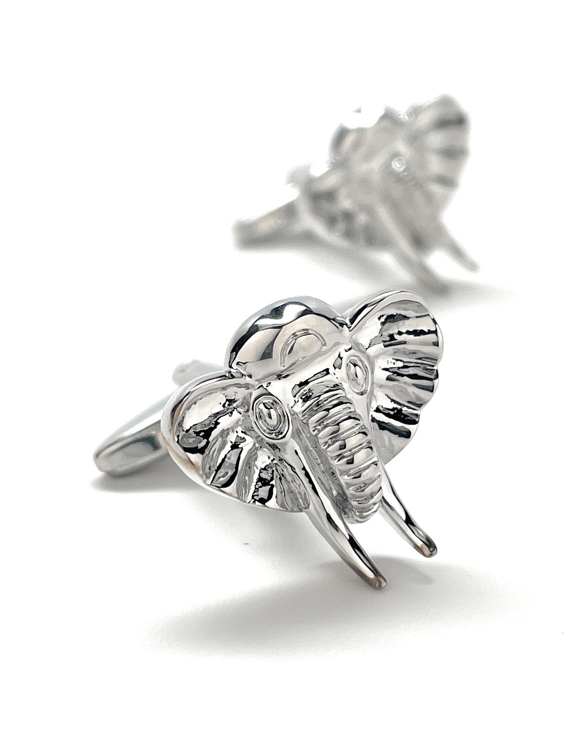 Silver elephant cufflinks on a white background