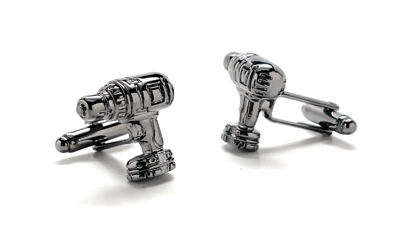 Silver cylindrical cufflinks on a white background