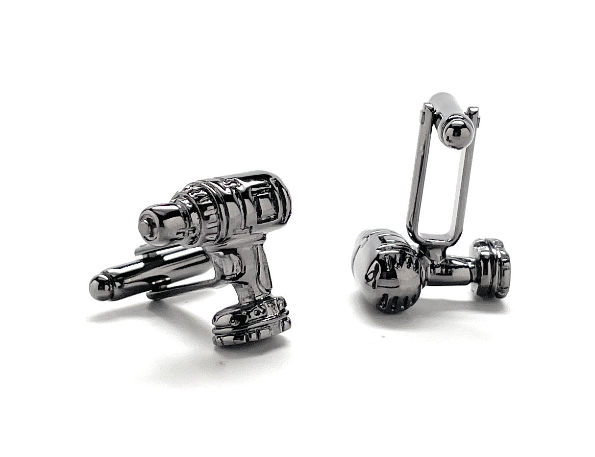Chrome toy gun-shaped cufflinks on a white background