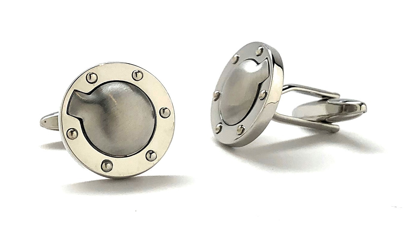 Pair of silver cufflinks with a textured design on a white background