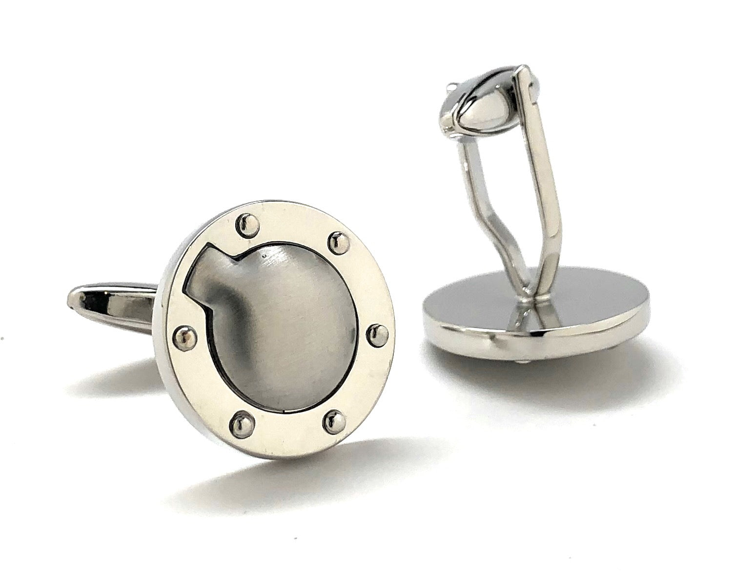 Silver cufflinks with a round design on a white background
