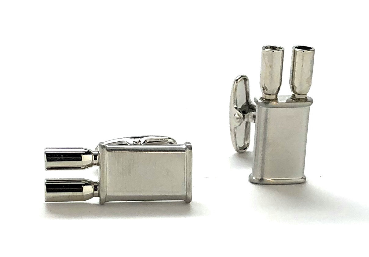 Silver cufflinks and lighter set on a white background