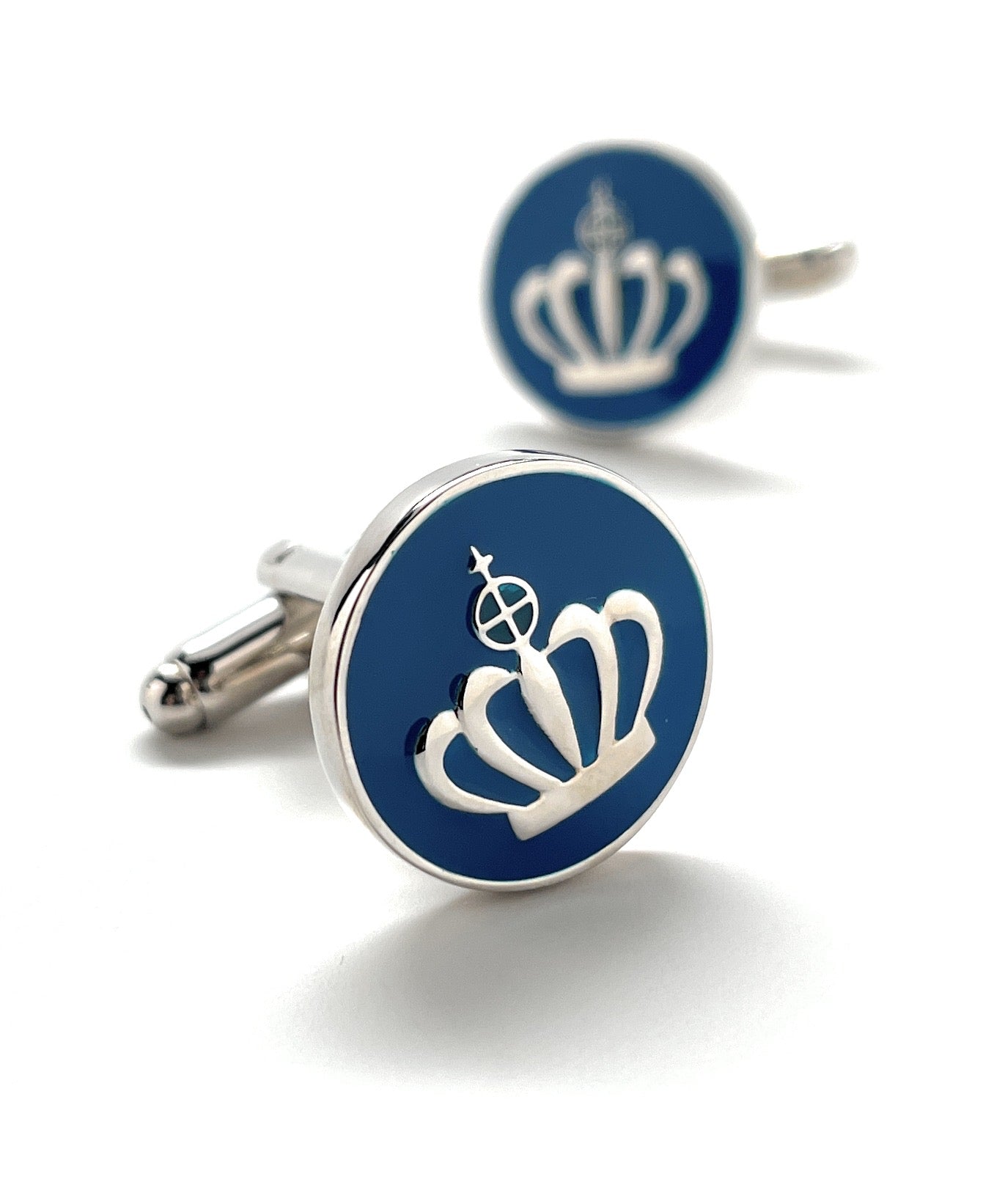 Cufflinks with a crown design on a blue background