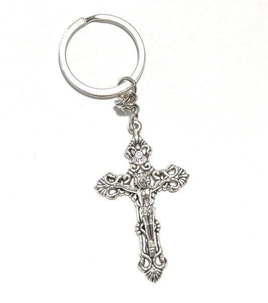 Silver crucifix keychain on a white background