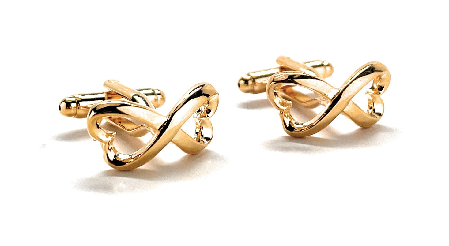 Pair of gold cufflinks on a white background