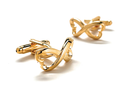 Gold bow-shaped cufflinks on a white background