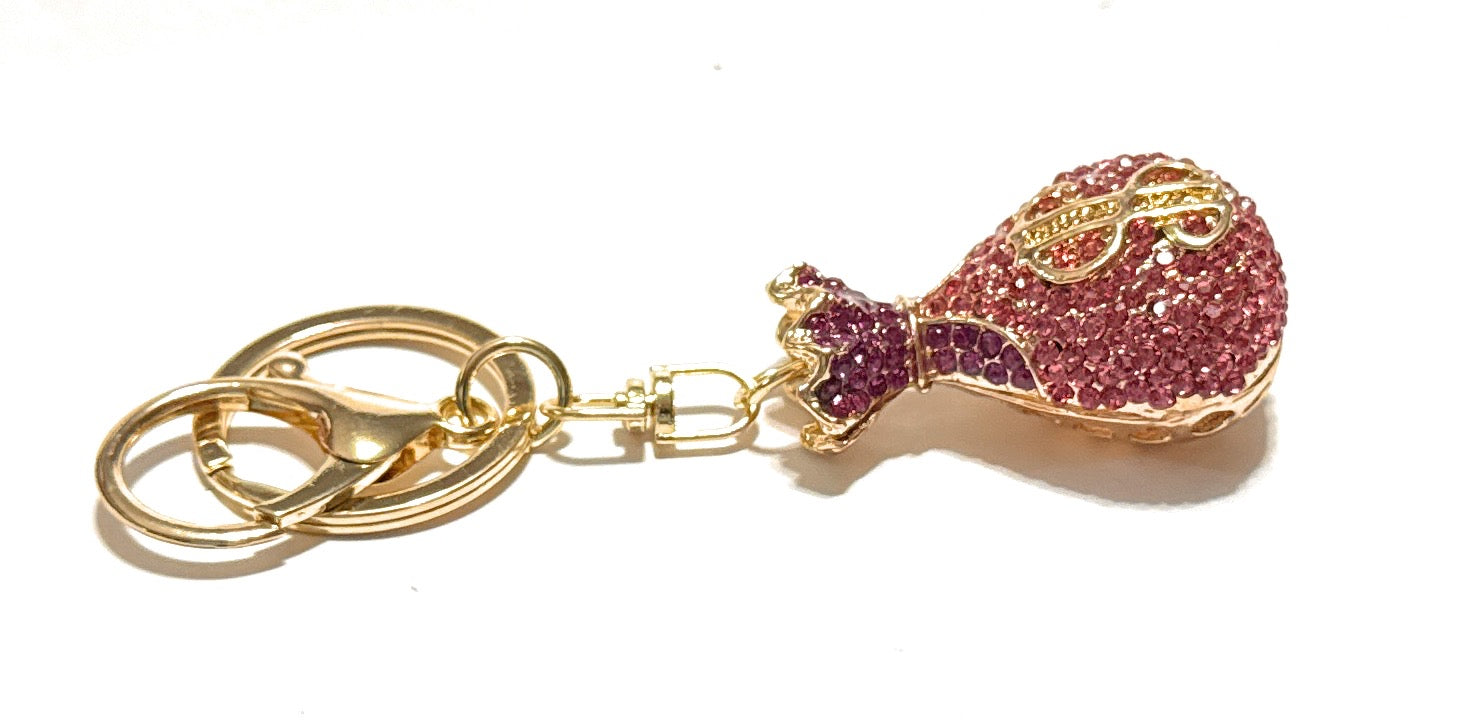 Keychain with pink glittery guitar-shaped charm on a white background