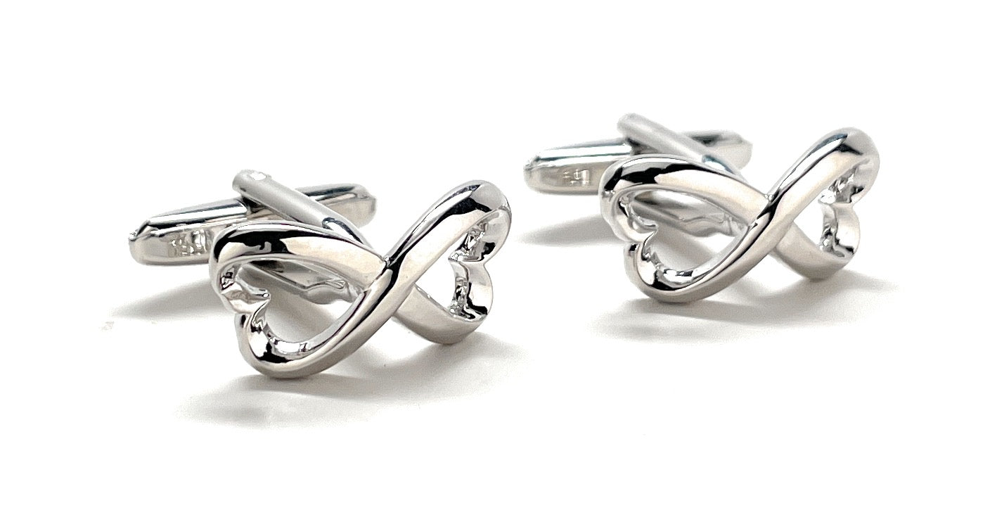 Pair of silver cufflinks on a white background