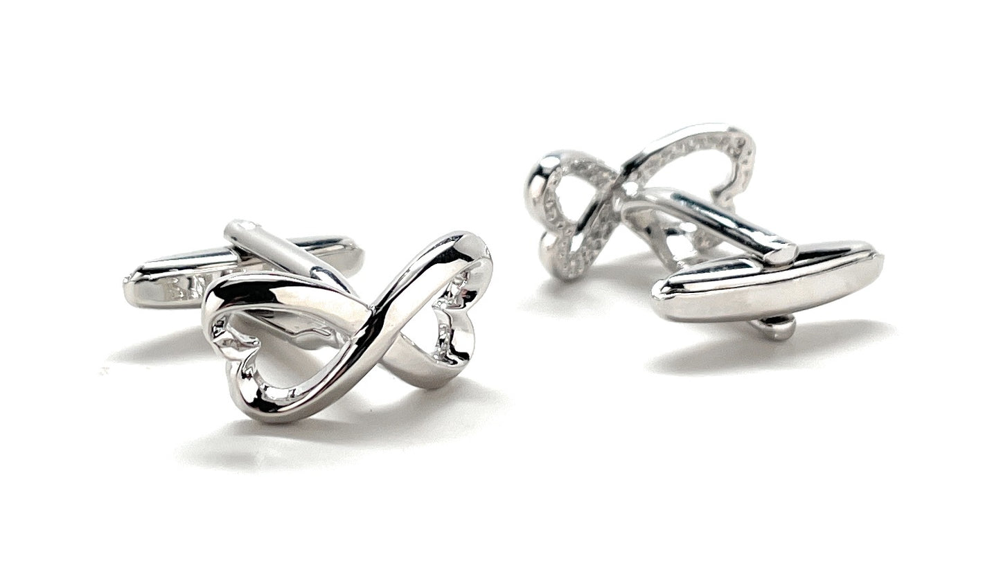 Silver bow-shaped cufflinks on a white background