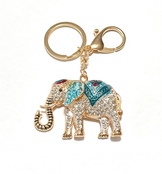 Decorative elephant keychain with gemstones on a white background