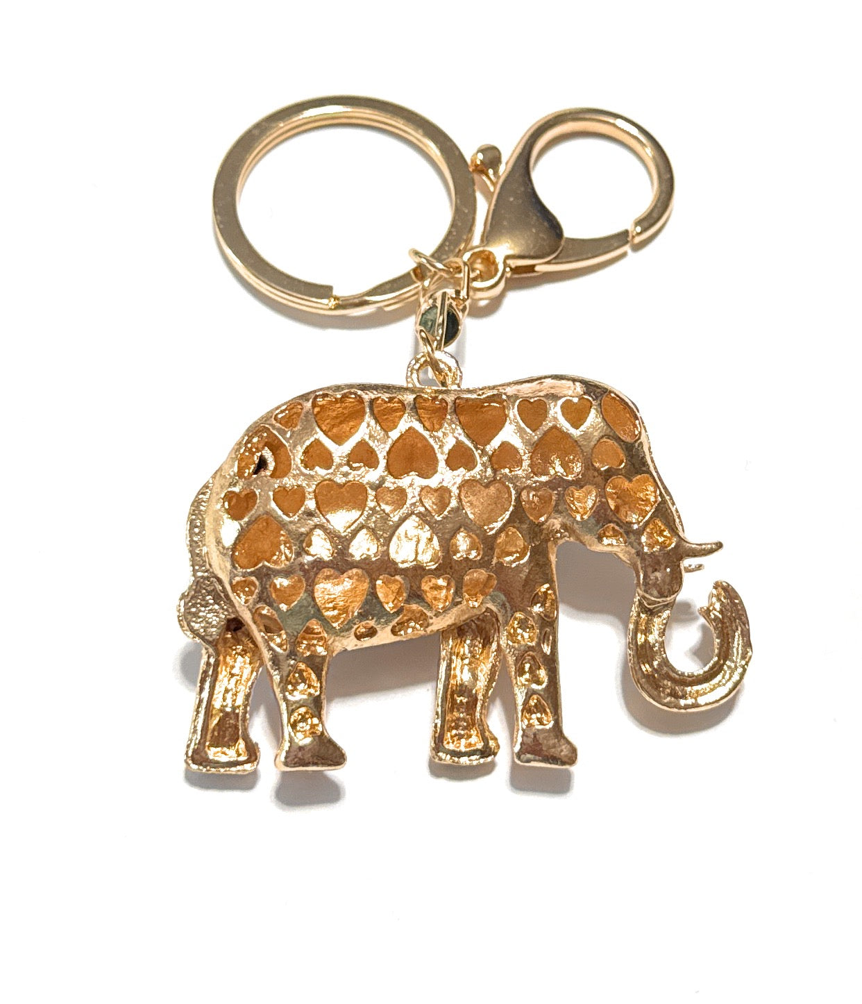 Gold elephant keychain with heart patterns on a white background