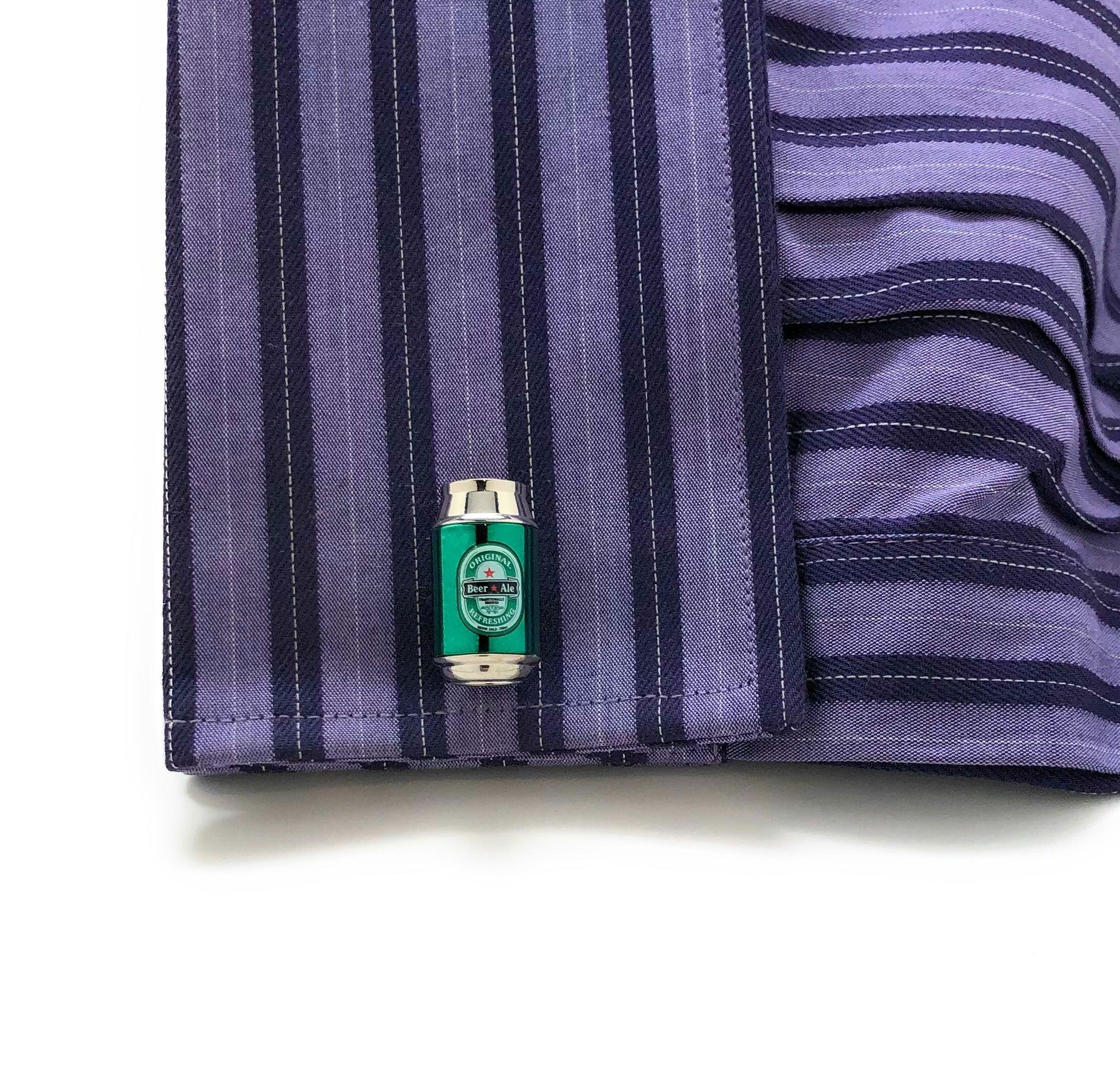 Close-up of a striped shirt with a cufflink on a white background