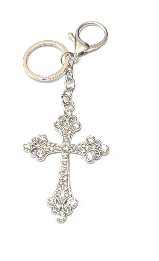 Silver cross keychain with clear stones on a white background