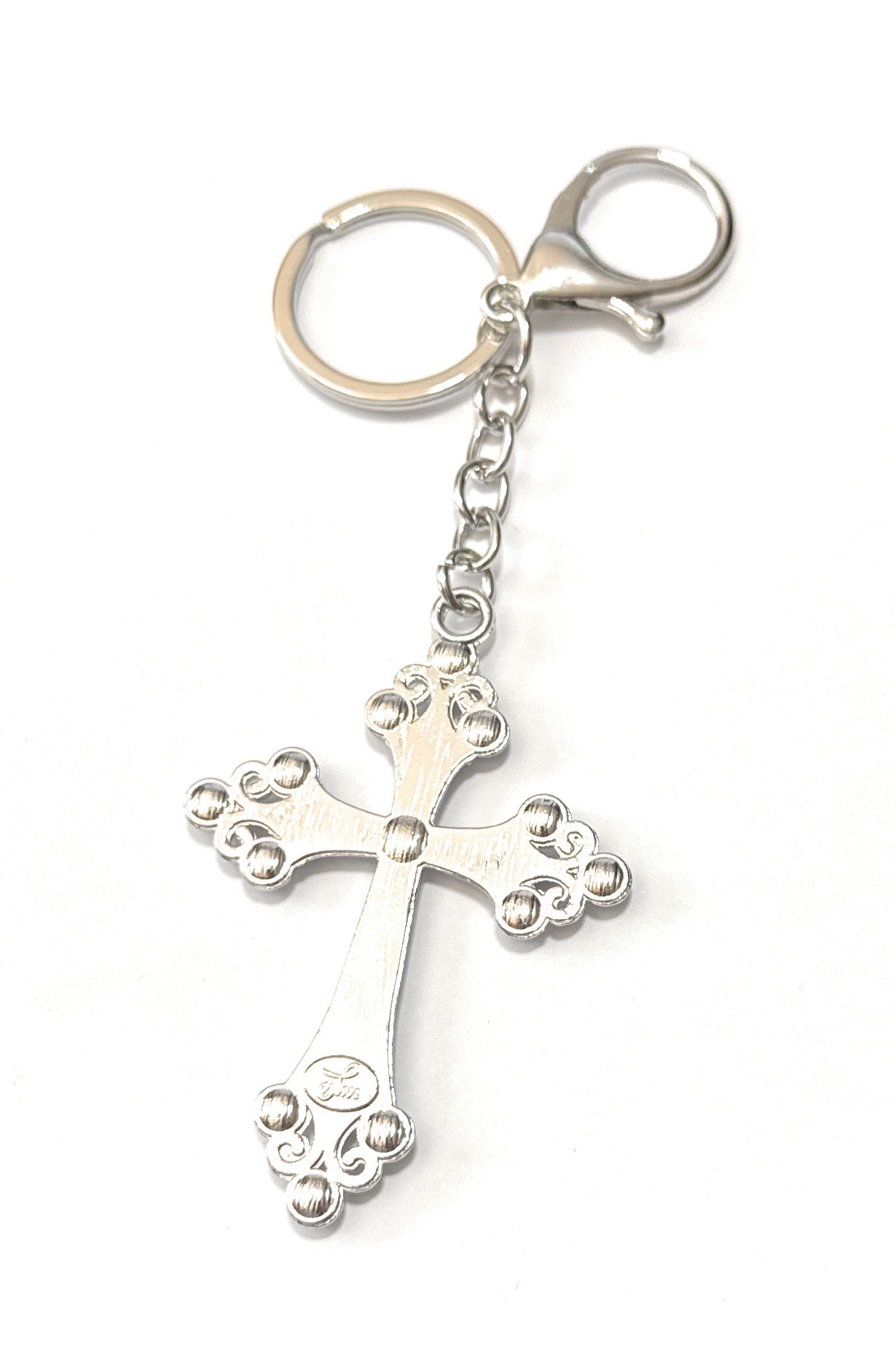 Silver cross keychain on a white background