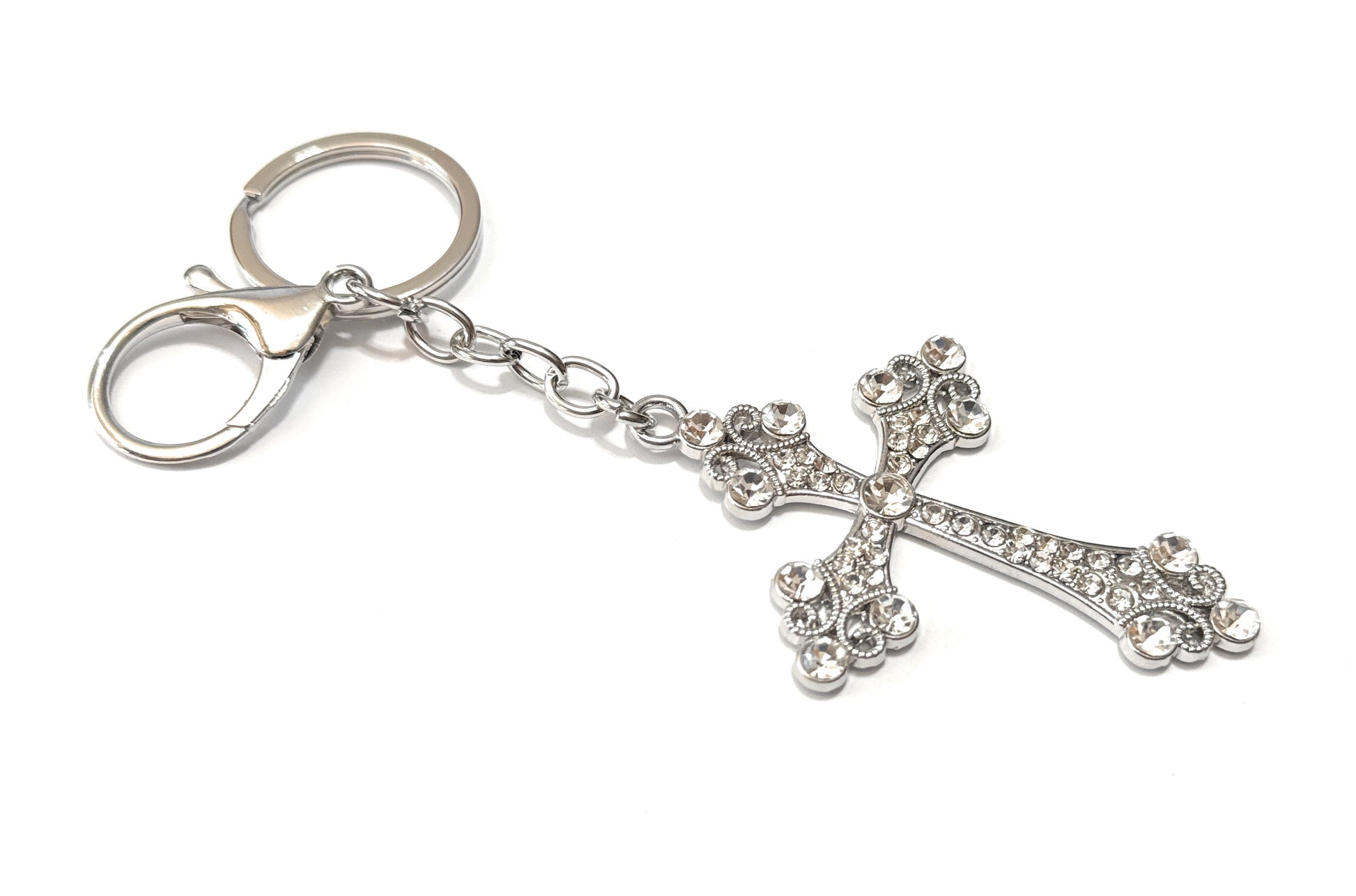 Silver cross keychain on a white background