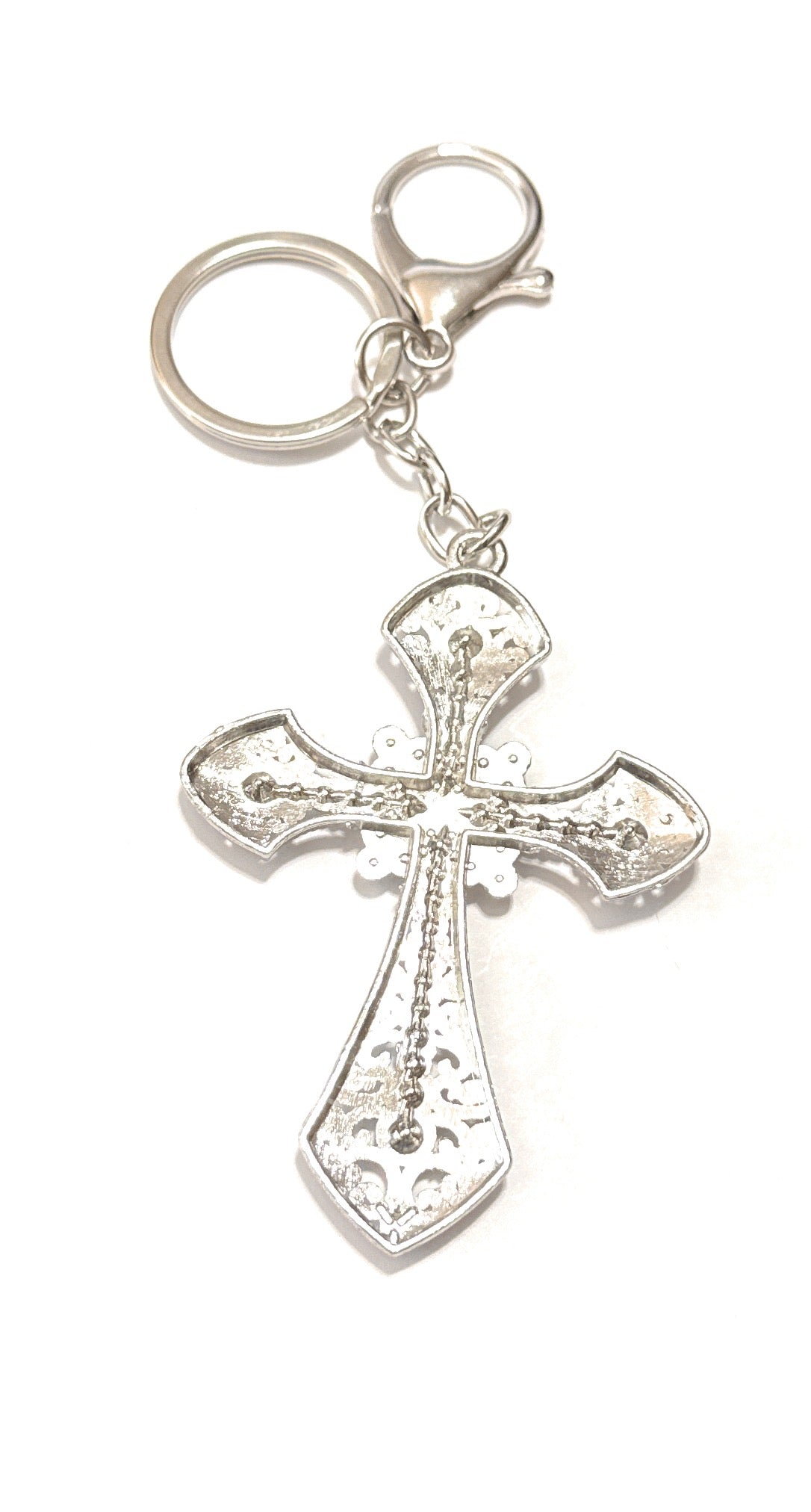 Silver cross keychain on a white background