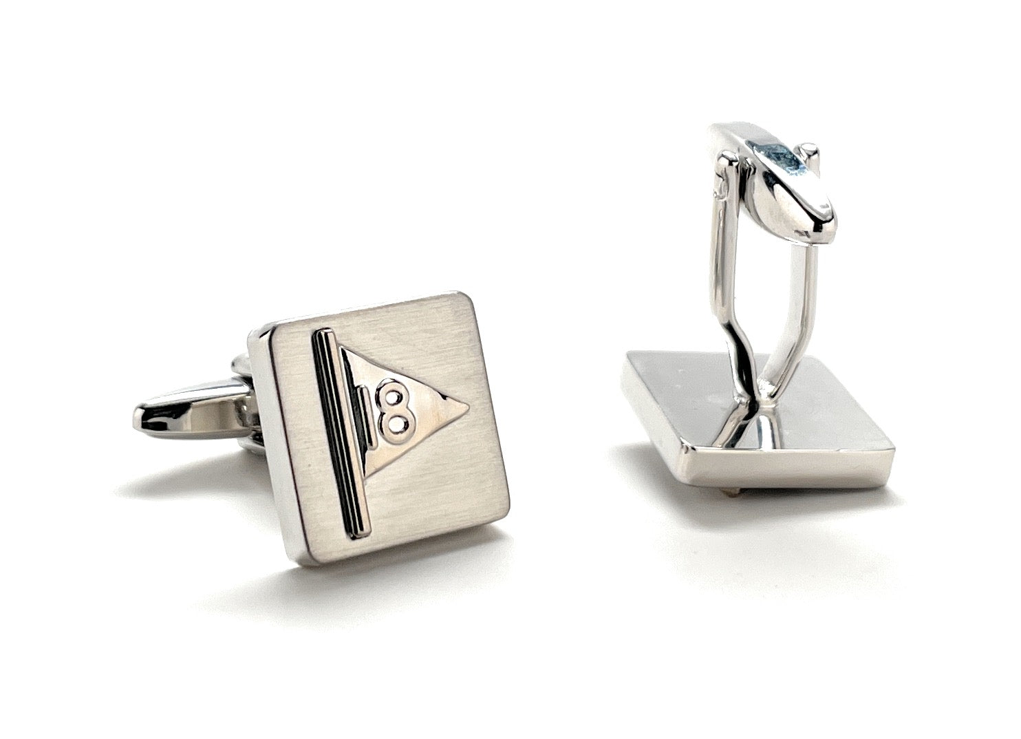 Silver cufflinks with a geometric design on a white background