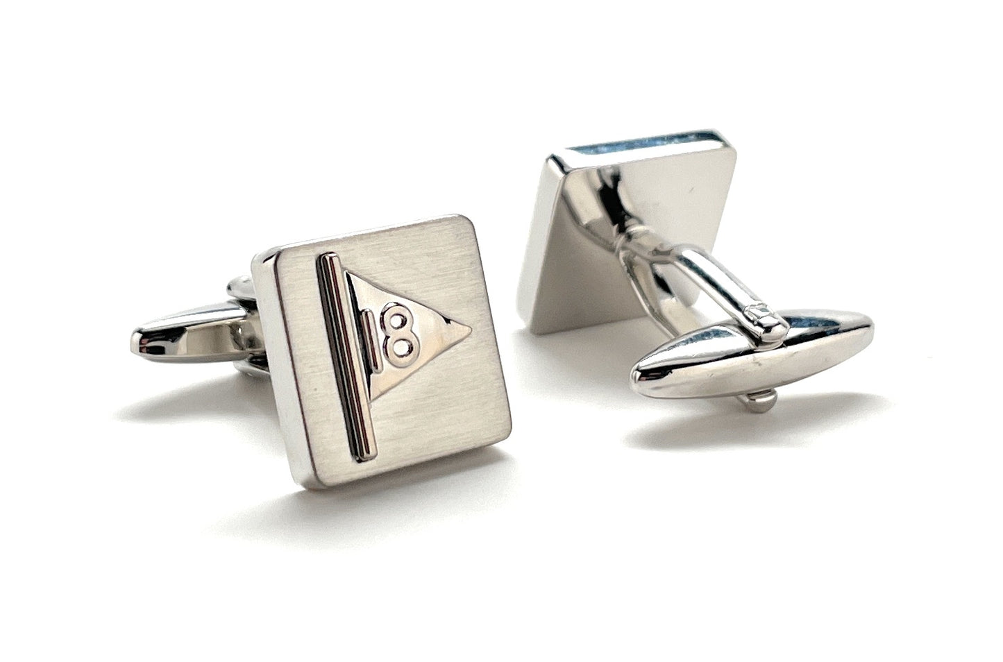 Pair of silver cufflinks on a white background