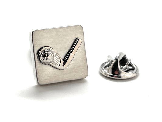 Silver lapel pin with a golf club and ball design on a white background