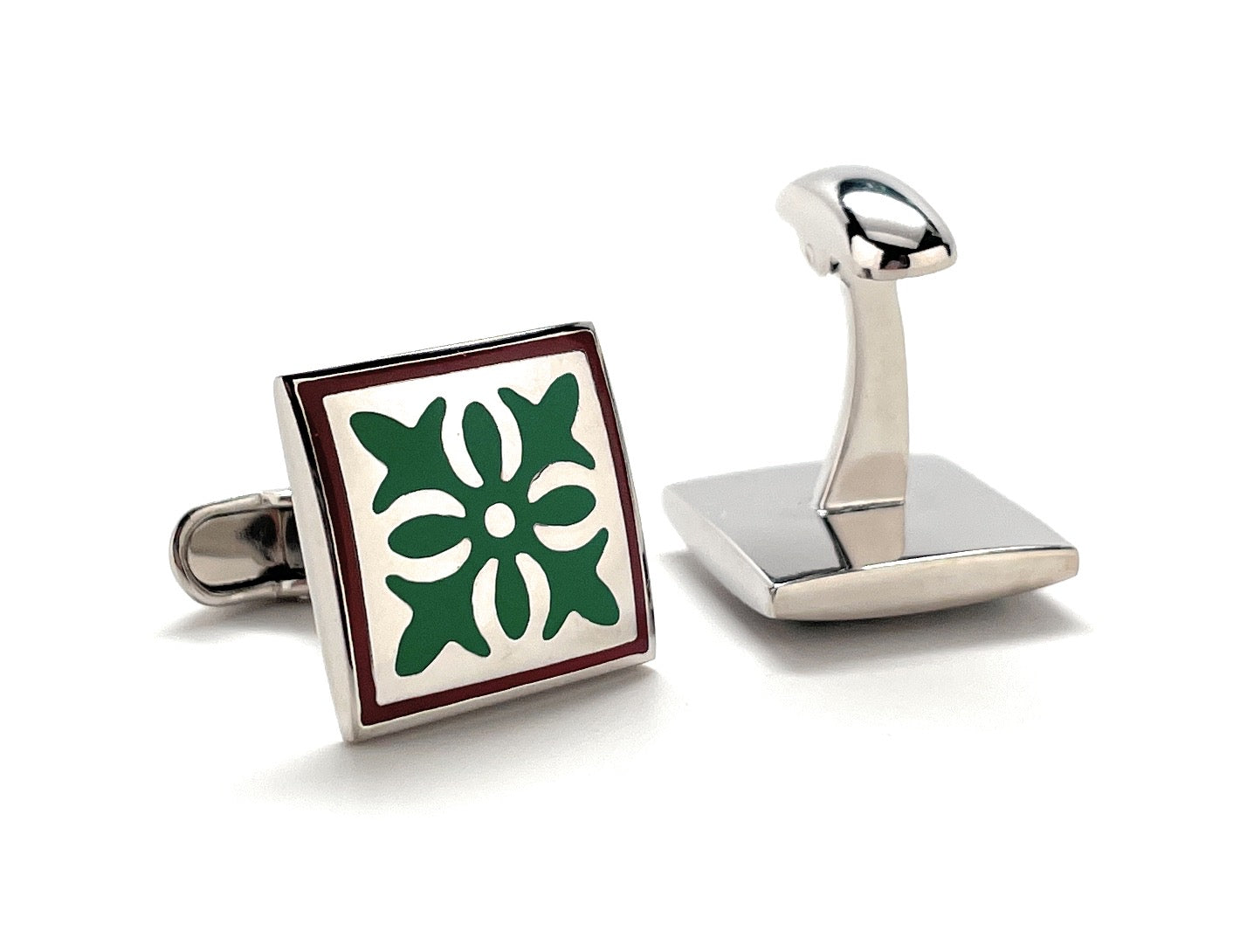 Cufflinks with a green floral design on a white background