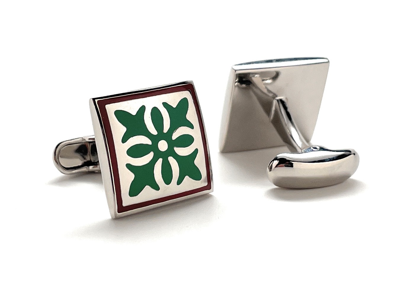Cufflinks with a green floral design on a white background