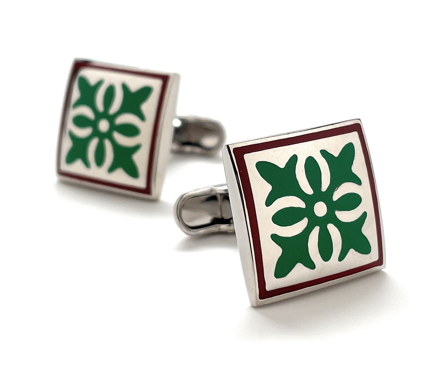 Square cufflinks with green floral design on a white background
