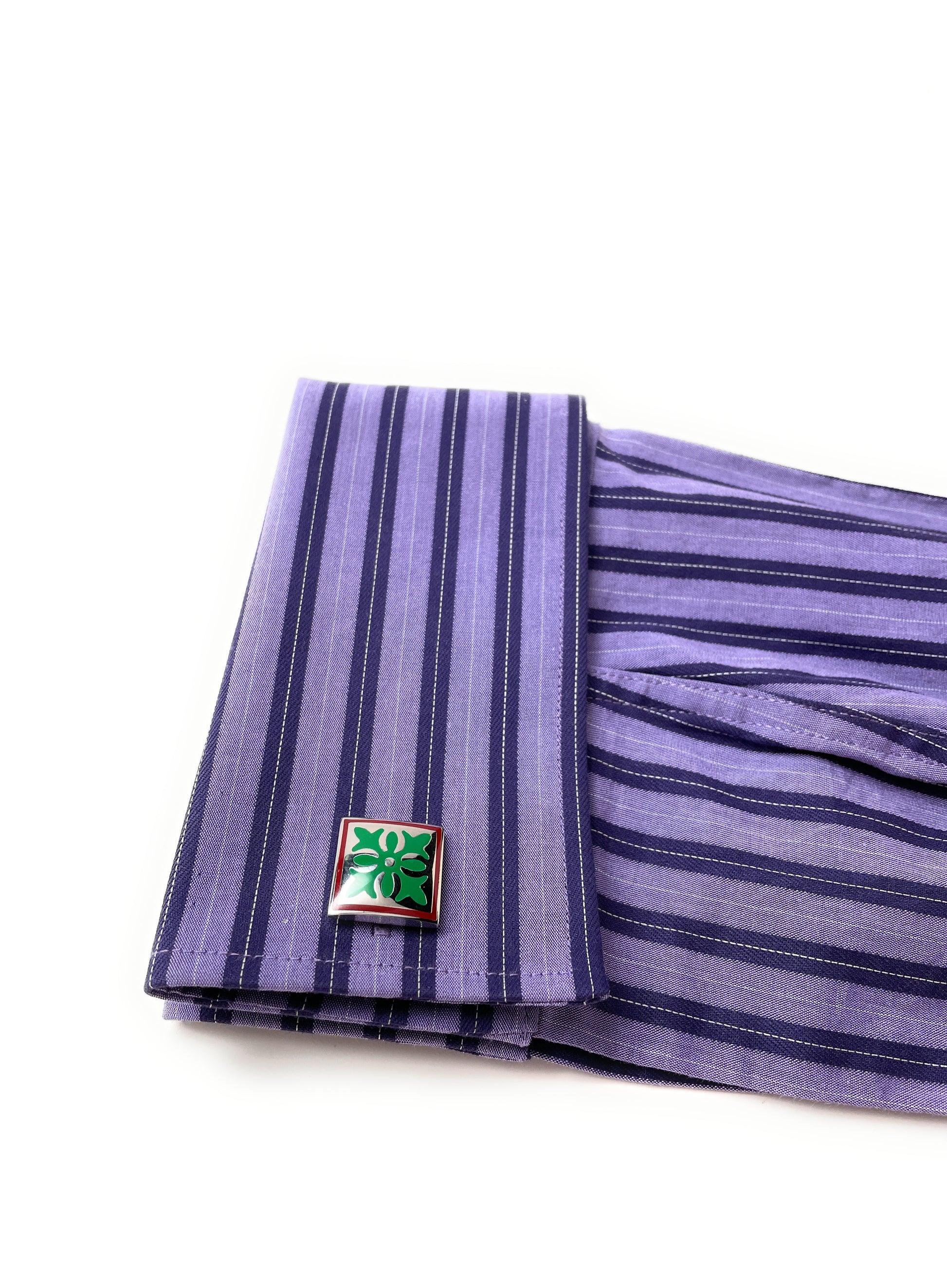 Purple striped fabric with a green and red emblem on a white background