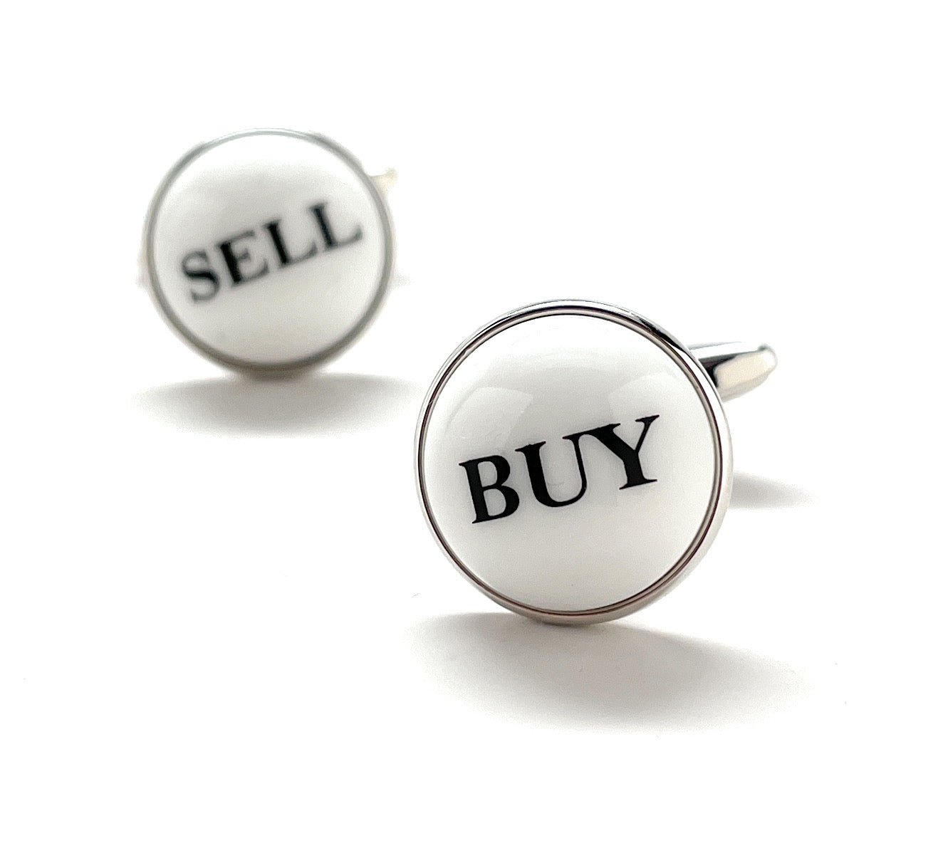 Cufflinks with 'SELL' and 'BUY' text on a white background