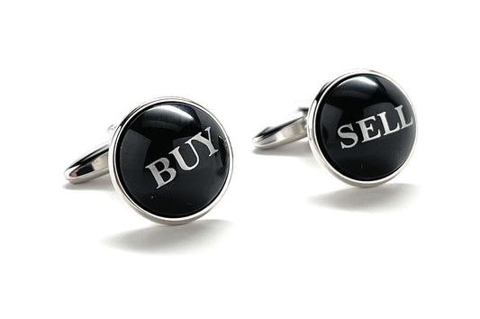 Cufflinks with 'BUY' and 'SELL' text on black stones against a white background