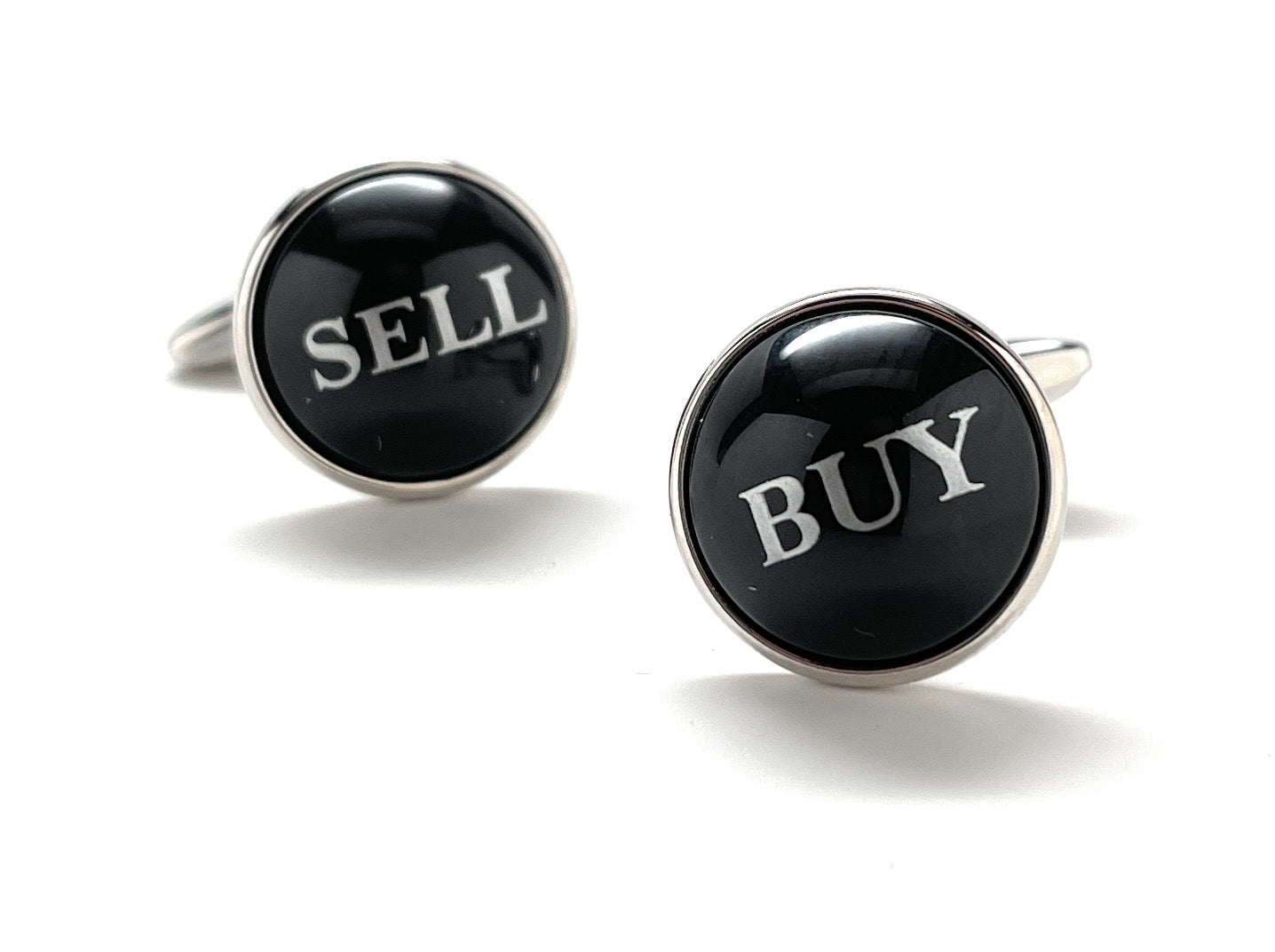 Cufflinks with 'SELL' and 'BUY' text on black round stones against a white background