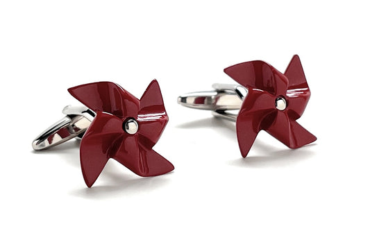 Red pinwheel-shaped cufflinks on a white background