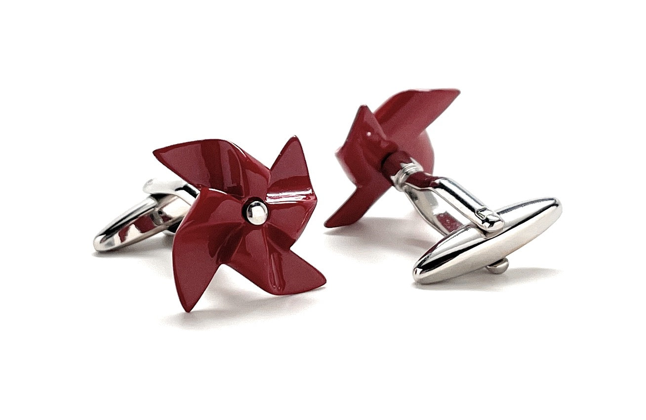 Red pinwheel-shaped cufflinks on a white background