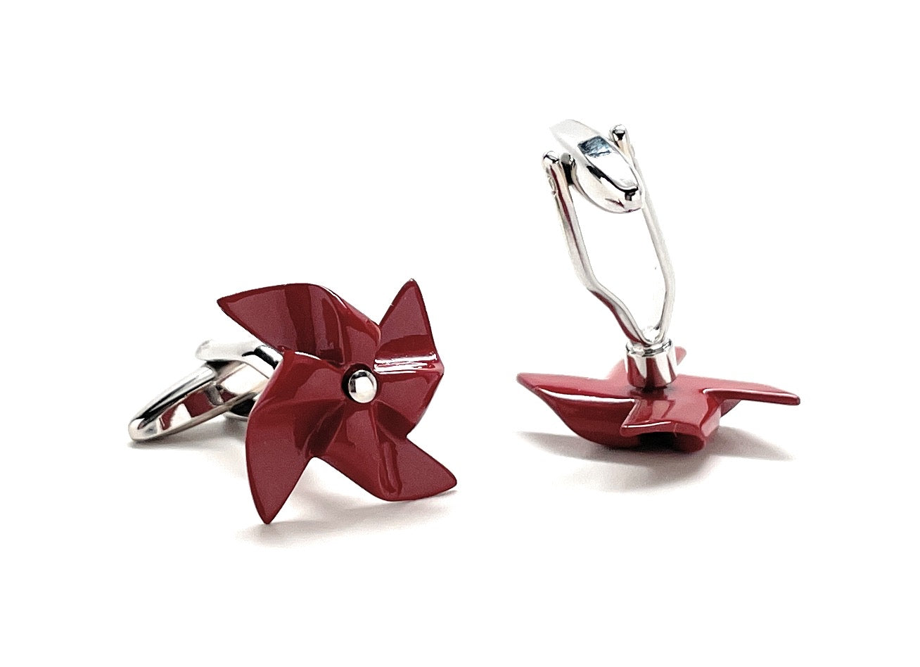 Red pinwheel-shaped cufflinks on a white background