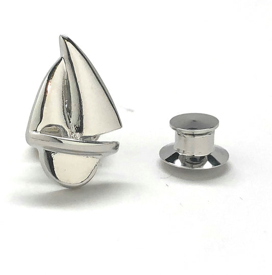 Silver sailboat cufflinks on a white background