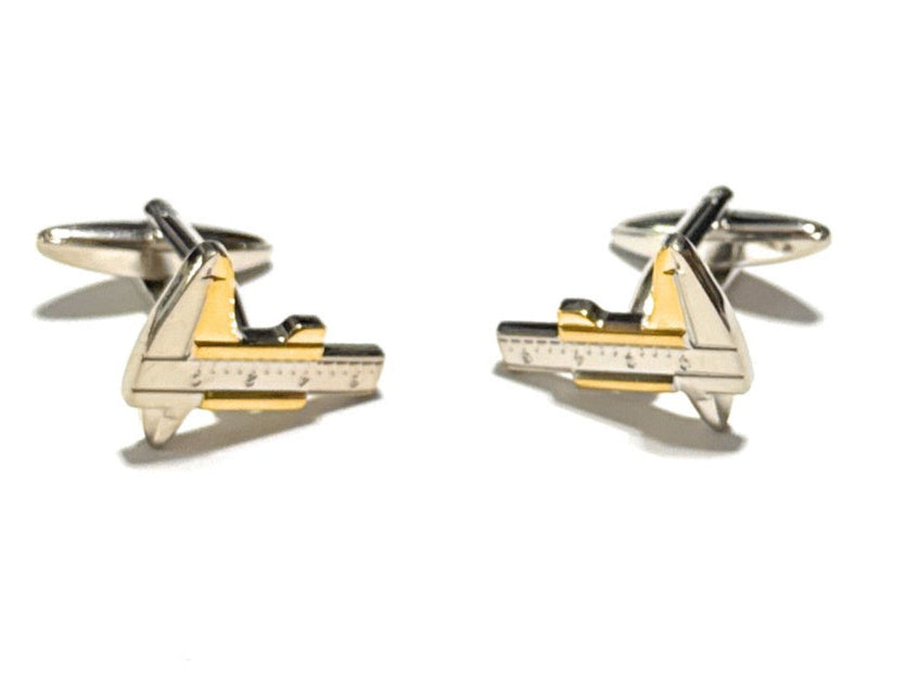 Gold airplane-shaped cufflinks on a white background