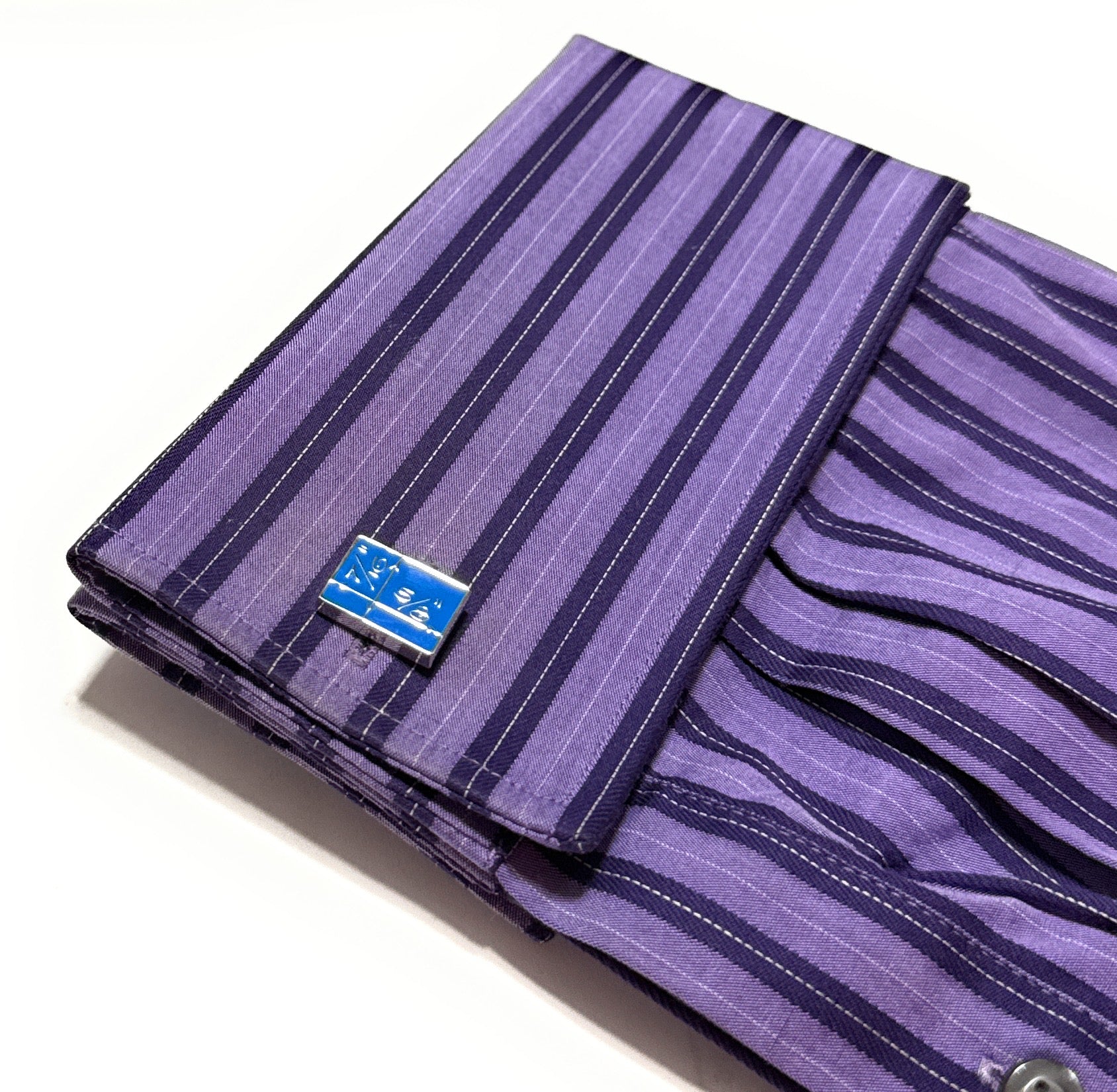 Purple striped fabric with a blue label on a white background