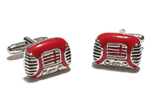Red and silver cufflinks shaped like vintage radios on a white background