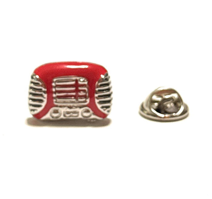 Red and silver vintage radio-shaped lapel pin on a white background