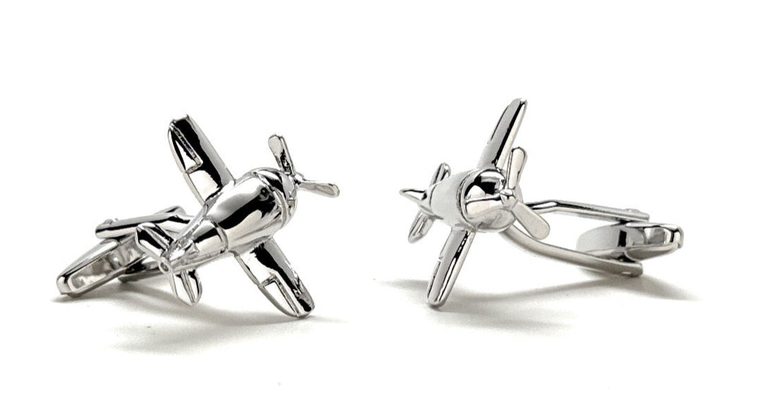 Silver airplane-shaped cufflinks on a white background