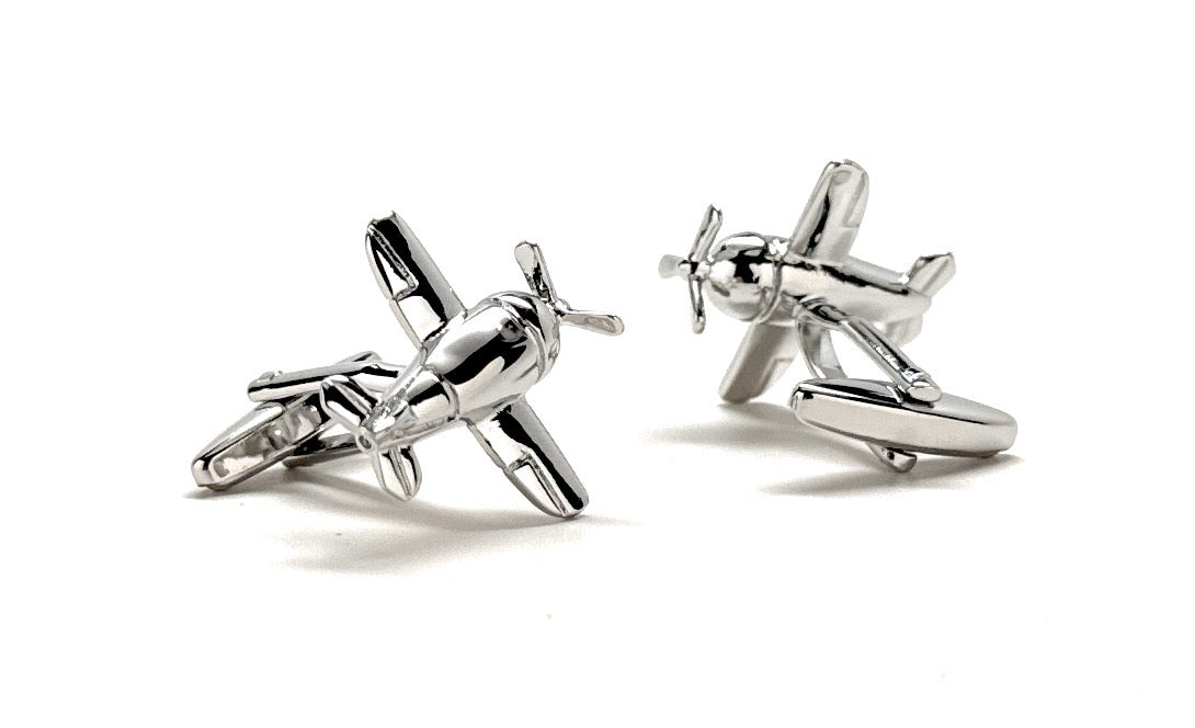 Silver airplane-shaped cufflinks on a white background