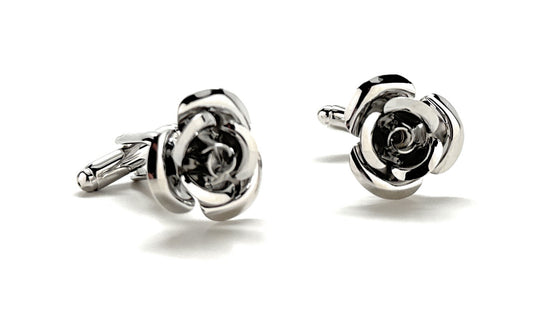 Silver rose-shaped cufflinks on a white background