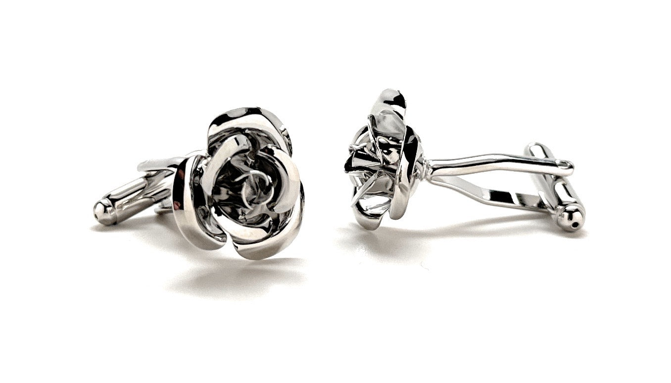 Silver rose-shaped cufflinks on a white background