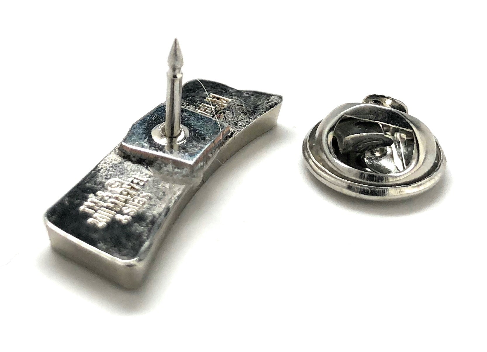 Spider-Man logo lapel pin with red enamel lettering on silver metal and secure clutch backing