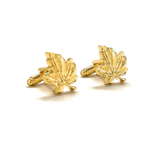 Gold leaf-shaped cufflinks on a white background